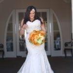 Lace plus size wedding gown with ribbon sash belt from Darius Bridal