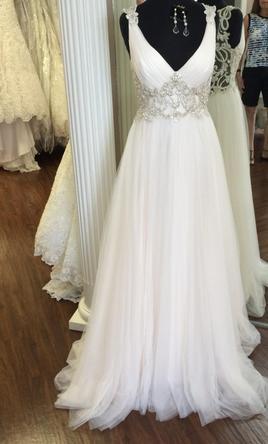 Sleeveless v-neck wedding gown with empire waist line from Darius Bridal