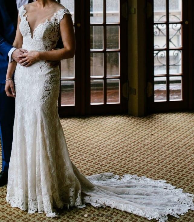 An off the shoulder cap sleeve wedding gown from Darius Bridal